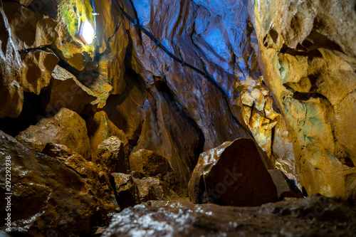 Natural high mountain cave, Mrozna cave in Tatras, yellow and brown rocks  photo