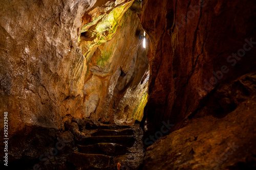 Natural high mountain cave, Mrozna cave in Tatras, yellow and brown rocks  photo