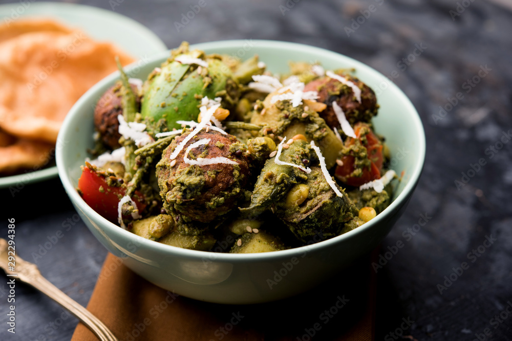 Undhiyu is a Gujarati mixed vegetable dish, specialty of Surat, India. Served in a bowl with or without poori Undhiyu is a Gujarati mixed vegetable dish, specialty of Surat, India. Served in a bowl with or without poori