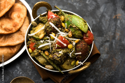 Undhiyu is a Gujarati mixed vegetable dish, specialty of Surat, India. Served in a bowl with or without poori photo