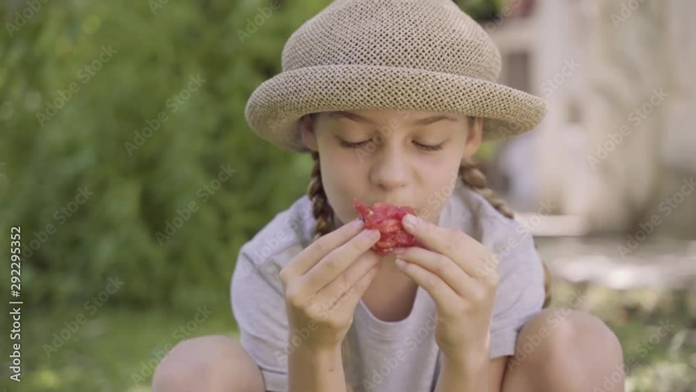 Portrait of a beautiful blonde little girl enjoying a savour organic tomato. Taste of red green natural healthy tomatoes.Eat healthy diet. Control children nutrition for an ideal health development. Portrait of a beautiful blonde little girl enjoying a savour organic tomato. Taste of red green natural healthy tomatoes.Eat healthy diet. Control children nutrition for an ideal health development.