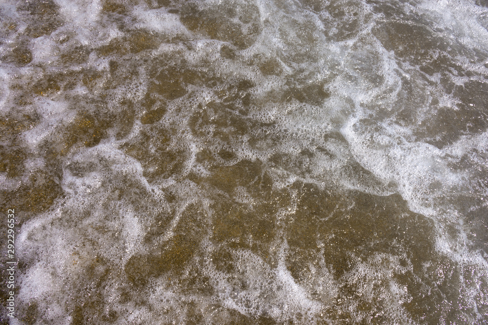 Close up sea water waves with bubbles Close up sea water waves with bubbles