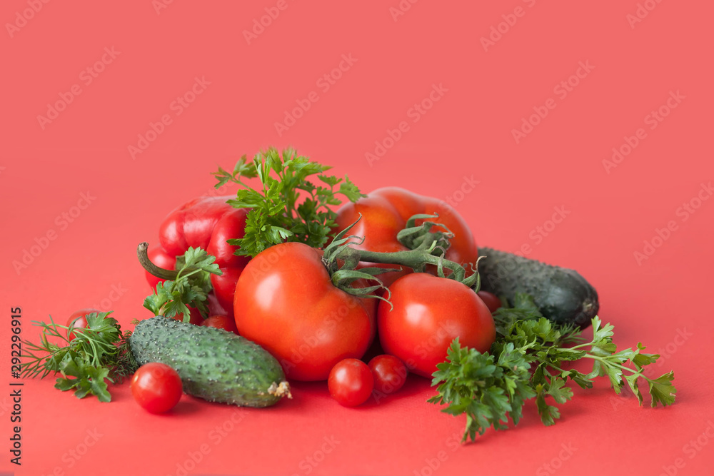Flat lay composition with fresh cucumber, green-stuff and tomatoes on red background with copy cpace Flat lay composition with fresh cucumber, green-stuff and tomatoes on red background with copy cpace