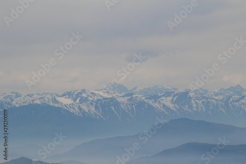 mountains view with clouds and mist from a peak