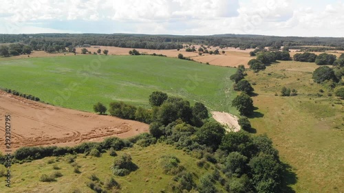 Aerial view over the idyllic Swedish hills Brosarps backar on Osterlen in Skane, Sweden. Open fields with farming crops photo