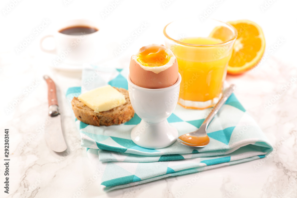 soft boiled egg with orange juice and coffee cup