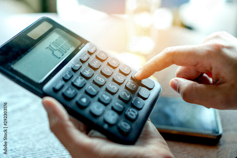Calculator and a stack of Bitcoins coins as symbol of cryptocurrency digital money in the future blockchain. Calculator and a stack of Bitcoins coins as symbol of cryptocurrency digital money in the future blockchain.