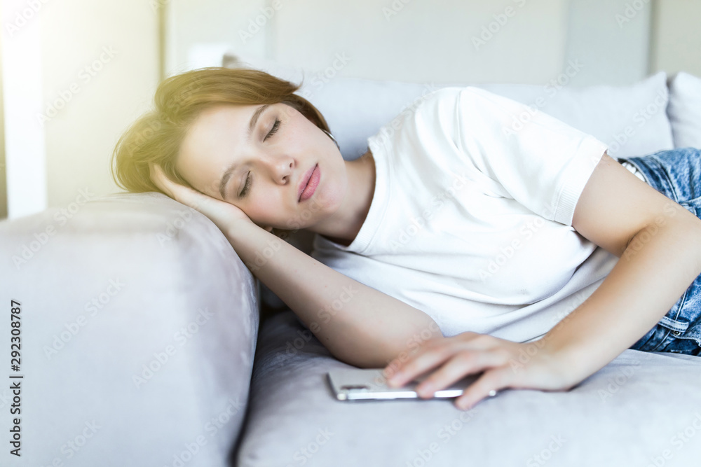 Beautiful young woman sleeping on sofa in lounge Beautiful young woman sleeping on sofa in lounge