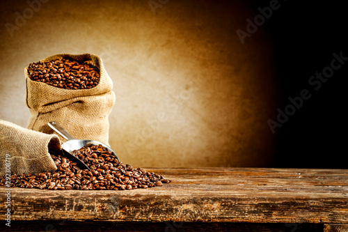 Fresh coffee in sacks and brown wooden desk of free space for your decoration with brown wall 