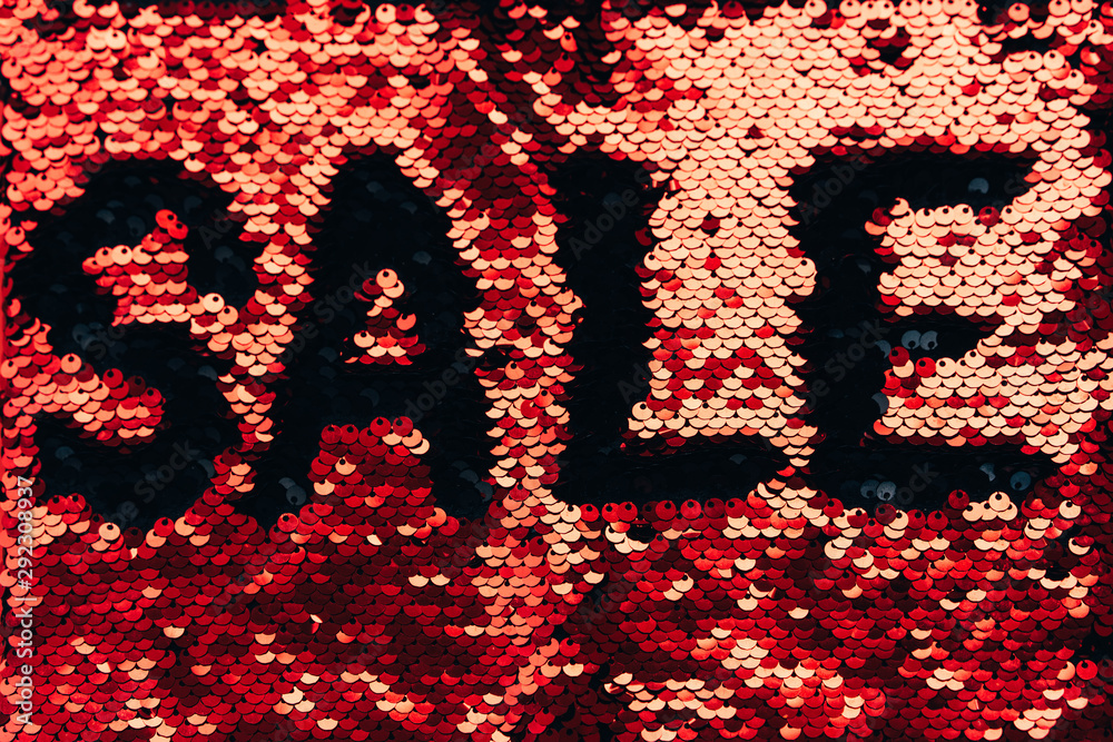 The inscription Sale made of red and black sequins. Festive concept of Christmas sales and discounts. Black Friday The inscription Sale made of red and black sequins. Festive concept of Christmas sales and discounts. Black Friday