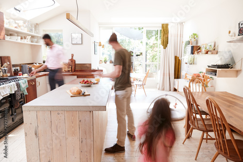 Same Sex Male Couple With Daughter Making Breakfast At Home Together photo