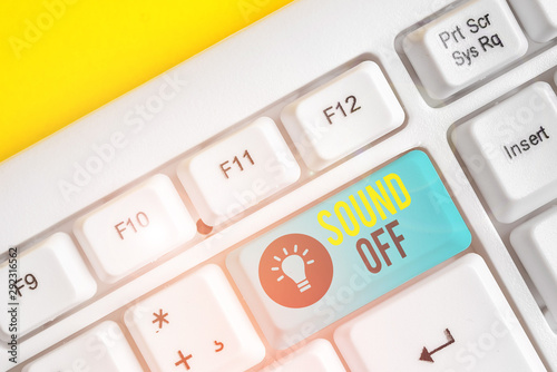 Conceptual hand writing showing Sound Off. Concept meaning To not hear any kind of sensation produced by stimulation White pc keyboard with note paper above the white background photo