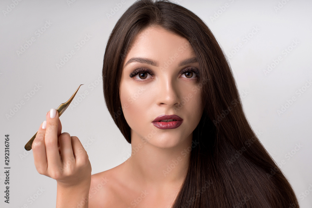 Portrait of young beautiful girl with young skin and long eyelashes. Professional makeup. Fashion, beauty, power Portrait of young beautiful girl with young skin and long eyelashes. Professional makeup. Fashion, beauty, power