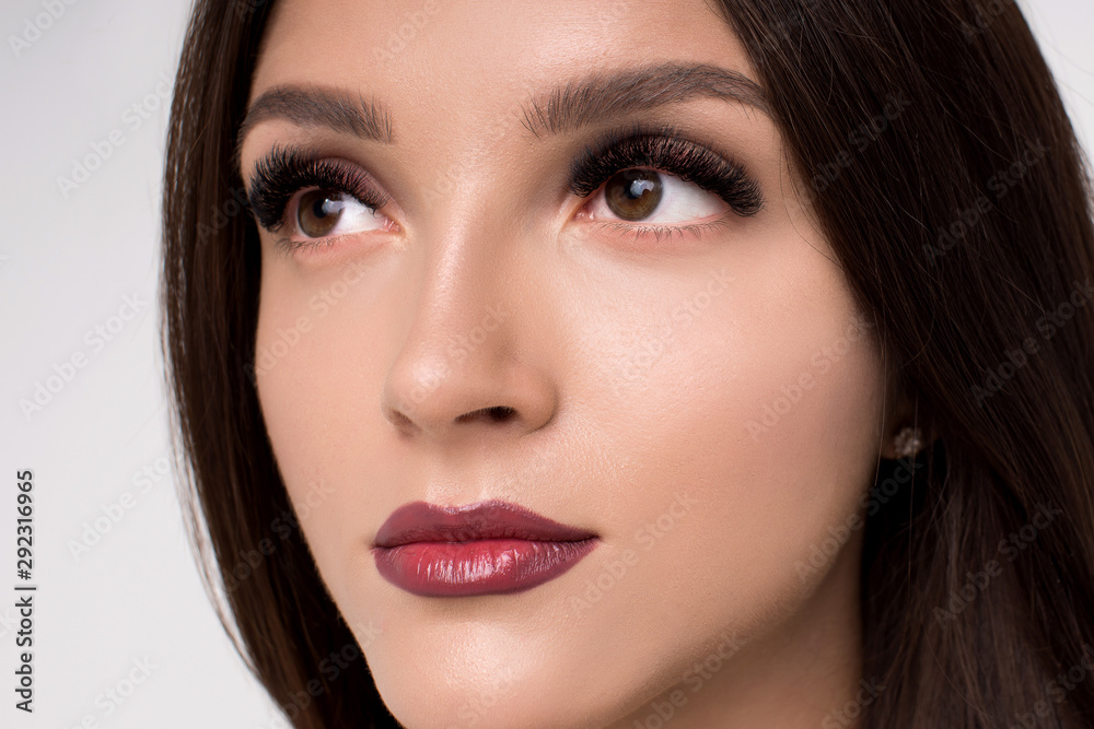 Beautiful woman brunette beauty hair and makeup face closeup Beautiful woman brunette beauty hair and makeup face closeup