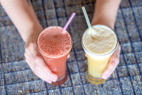 Wallpaper Mural Woman hands holding two glasses with pineapple and watermelon fresh juice, close up Torontodigital.ca