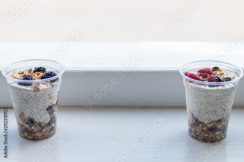 Chia pudding with yogurt, blackberries, raspberries, bananas and oatmeal served in cups