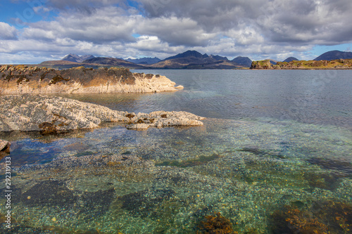 The ​Isle of Skye, Scotland seascape with dramatic clouds and pristine water the Cuillins