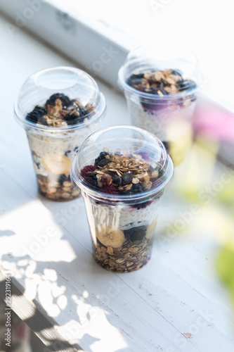 Chia pudding with yogurt, blackberries, raspberries, bananas and oatmeal served in cups