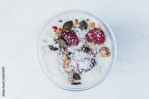 Chia pudding with yogurt, blackberries, raspberries, bananas and oatmeal served in cups