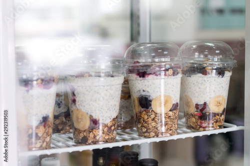 Chia pudding with yogurt, blackberries, raspberries, bananas and oatmeal served in cups