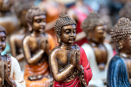 Buddha statue figures souvenir on display for sale on street market in Bali, Indonesia. Handicrafts and souvenir shop display, close up © OlegD