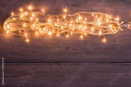 Party lights decoration. Wooden background with christmas lights garland