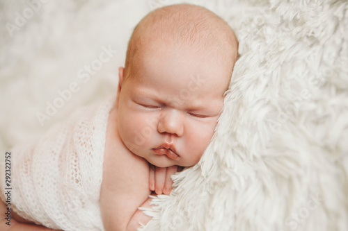 the concept of healthy lifestyle, IVF - a newborn baby sleeps under a blanket. Head, legs and arms