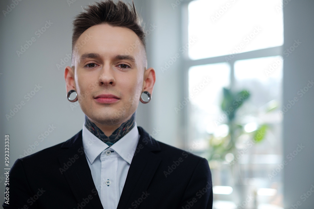 Portrait of alternative model with earplugs and tattoo Portrait of alternative model with earplugs and tattoo