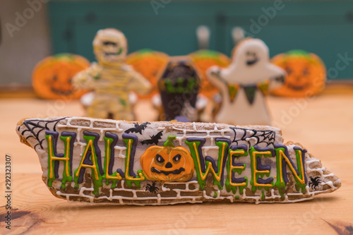 Halloween decals on gingerbreads and ghosts in the background in unfocus. Preparing for a Halloween party. Festive table photo