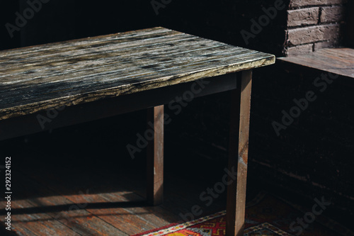 Old wooden table in the dark room