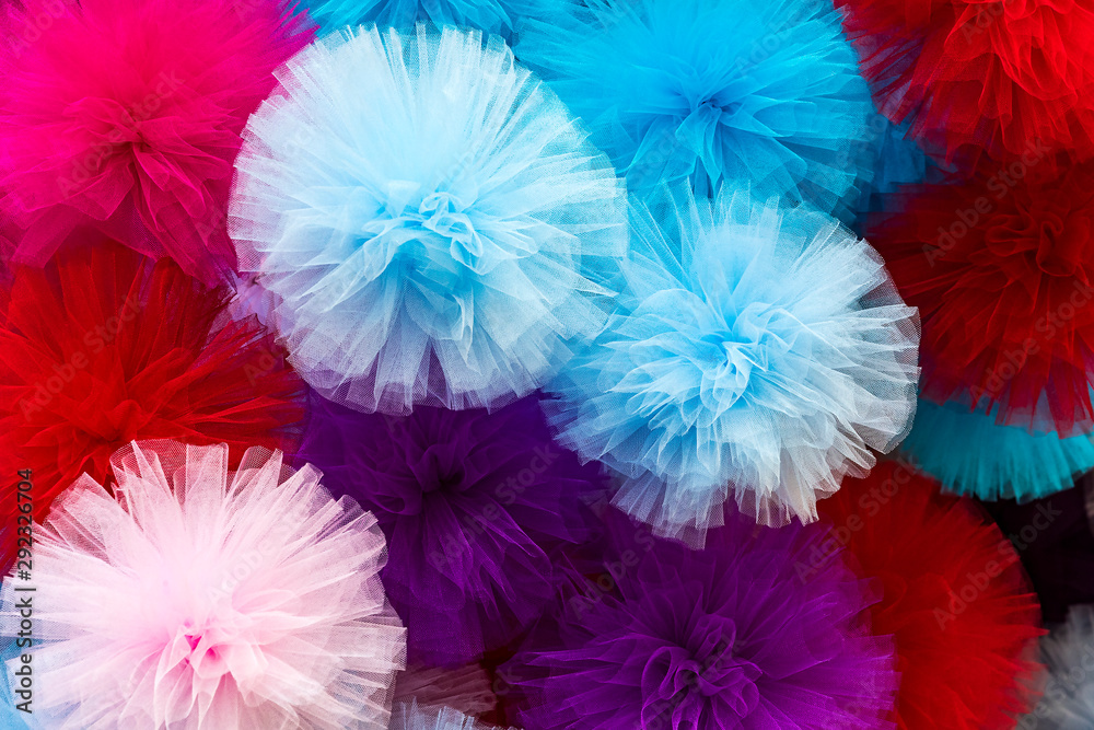 Colored fabric in the form of bows closeup background