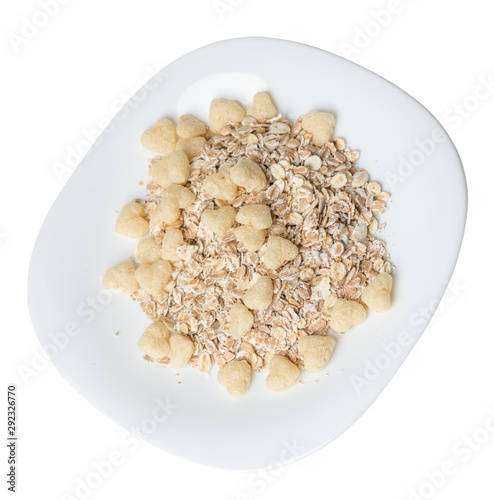  healthy breakfast on a plate isolated on white background.muesli with cornflakes, raisins, dates, pears and pineapple dried cashew nuts.breakfast top view photo