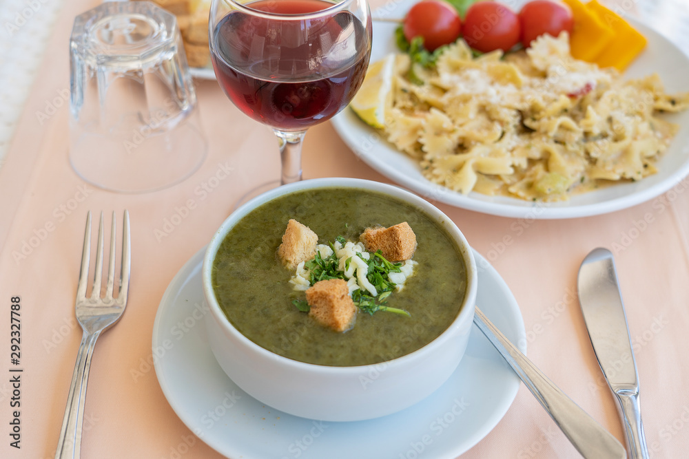 Green cream soup from spinach with croutons, cheese and fresh parsley Green cream soup from spinach with croutons, cheese and fresh parsley