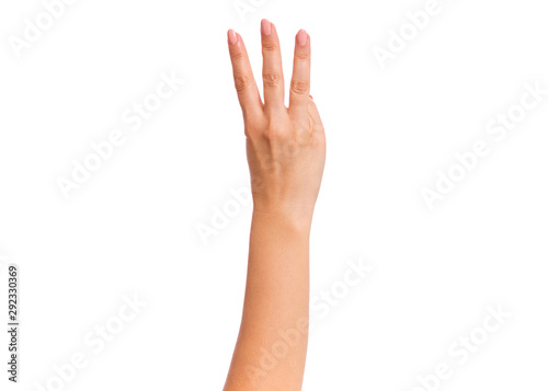 Female hand showing 3 fingers gesture, isolated on white background. Beautiful hand of woman with copy space. Hand doing gesture of number Three. Series of photos count from 1 to 5. © DenisNata