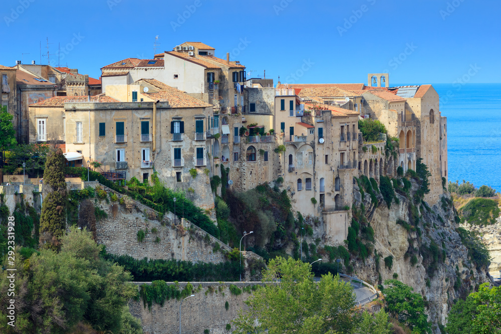 Scenic view on side walls of ancient Tropea town on mountain rock, South Italy