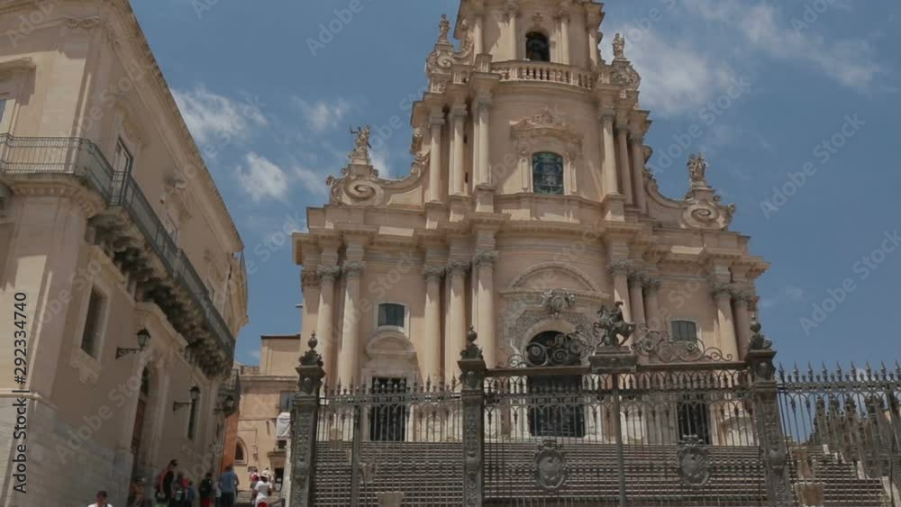 Some tourists visiting the baroque cathedral in the historic center of Ragusa Ibla in Sicily, Italy. Some tourists visiting the baroque cathedral in the historic center of Ragusa Ibla in Sicily, Italy.