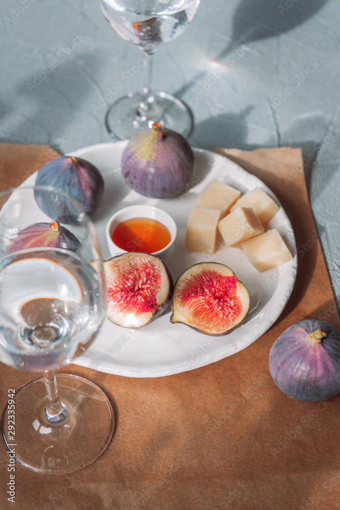 Figs, cheese and honey on a white plate Figs, cheese and honey on a white plate
