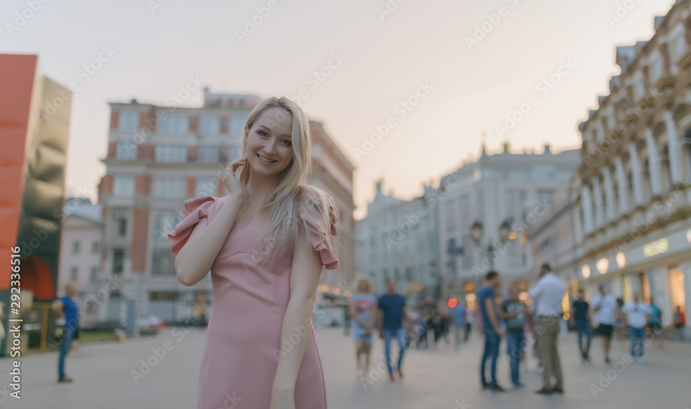Outdoor portrait of beautiful young woman at street. Selective focus.