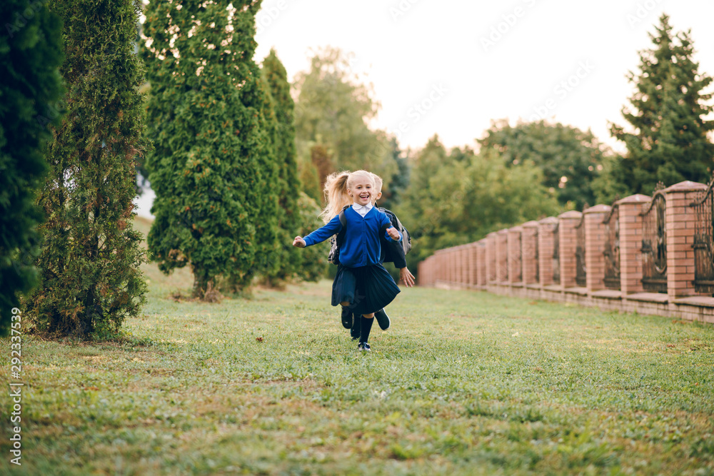 Cute kids with backpacks on their back running to school having fun. Back to school. Cute kids with backpacks on their back running to school having fun. Back to school.