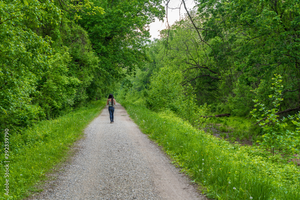 Woman walking down path along Chesapeake and Ohio Canal Woman walking down path along Chesapeake and Ohio Canal