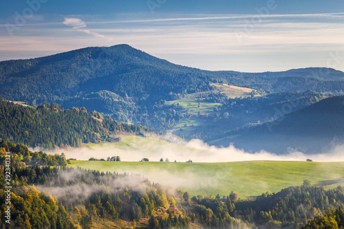Fog in the valleys of the mountain landscape in autumn morning. The Orava region near the village of Zazriva in Slovakia, Europe.