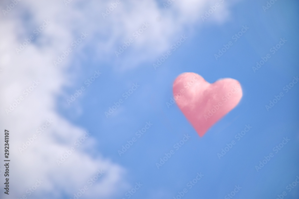 Heart shaped clouds on blue sky background