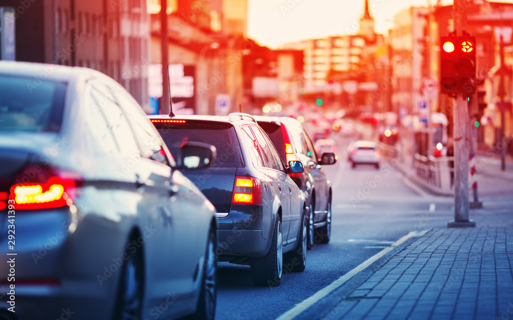 Cars moving on the road in city in late evening