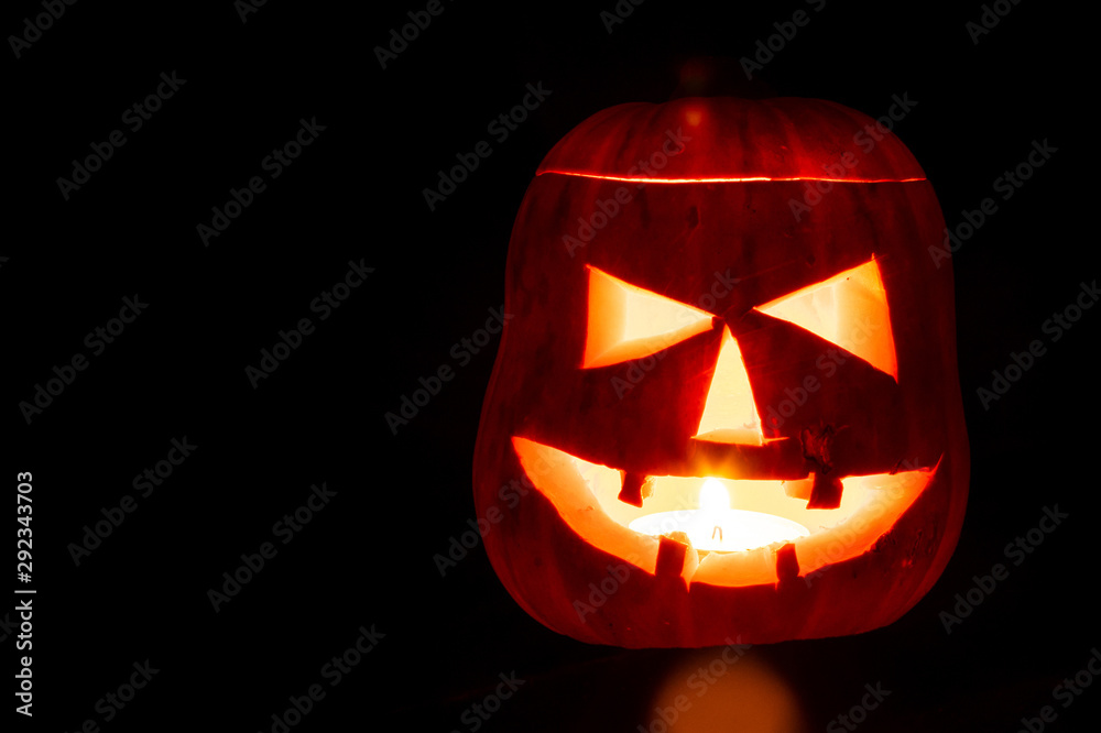 Halloween pumpkin with a scary face on a black background. Jack o lantern. Autumn holiday. Halloween pumpkin with a scary face on a black background. Jack o lantern. Autumn holiday.