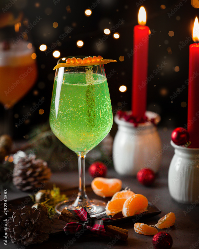 Green sparkling water in christmas table with red candles