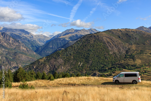 Caravelle T6 van parked on the mountain with sunrise with clouds