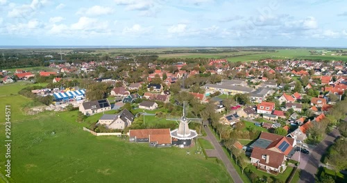 A Traditional Windmill “De Verwachting” in Hollum, the Dutch Island Ameland, The Netherlands. Flying Backwards. 4K Drone Footage. photo