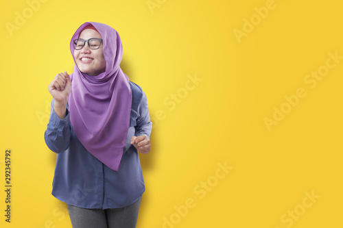 Happy Funny Asian Muslim Woman Dancing Full of Joy © airdone
