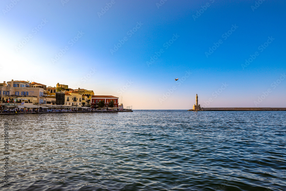 Interesting photo of Chania harbor with bird between old town and lighthouse.
