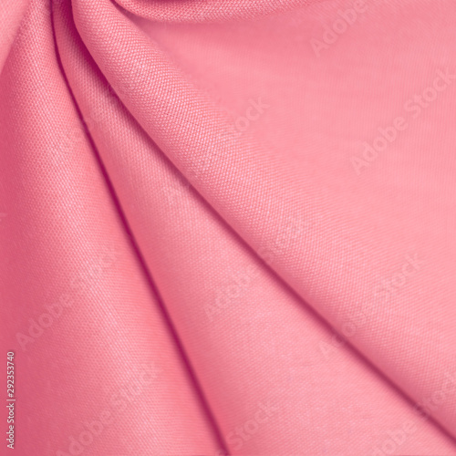 Texture of delicate pink fabric. Selective soft focus.